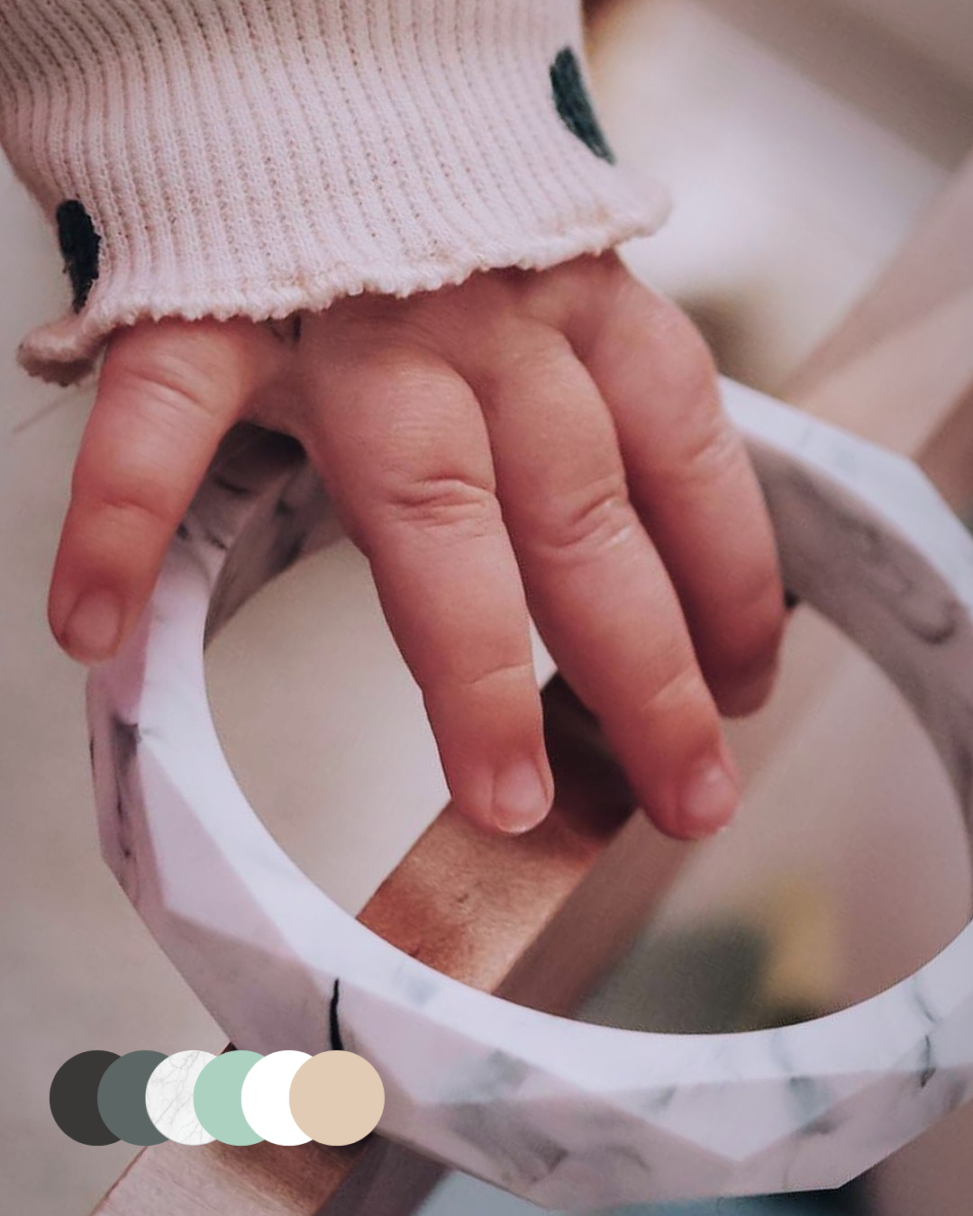 marble teething bracelet held by child- blossy mama