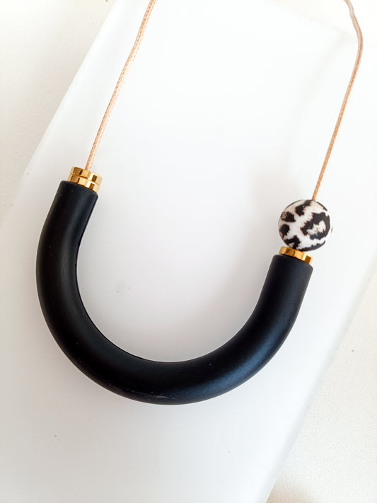 Leopard print breastfeeding necklace with teething ring in black and gold