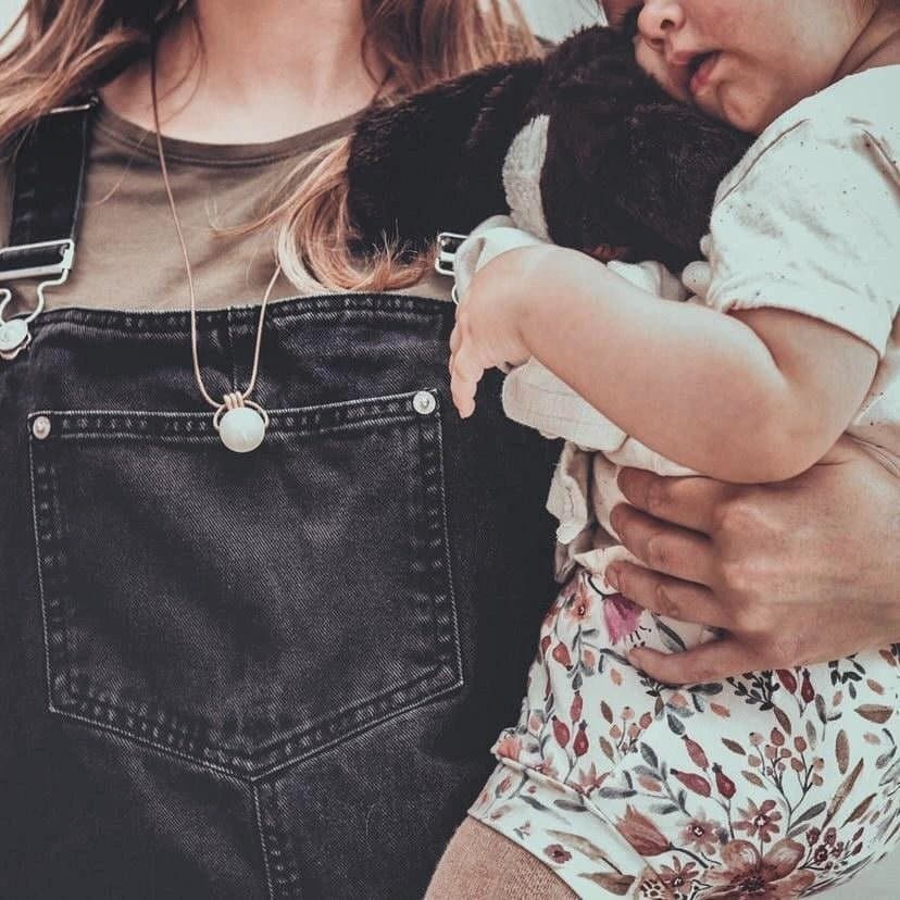 Antique Pearl breastfeeding and teething necklace ivory pearl white gold beads worn by mum holding baby