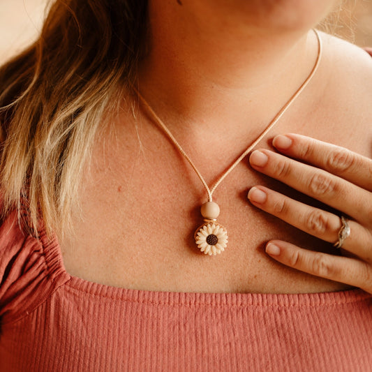 Dainty Daisy chewable silicone teething Pendant worn by mum - blossy