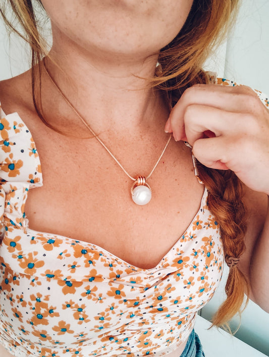 Ivory white Pearl necklace with rose gold detail worn by mama