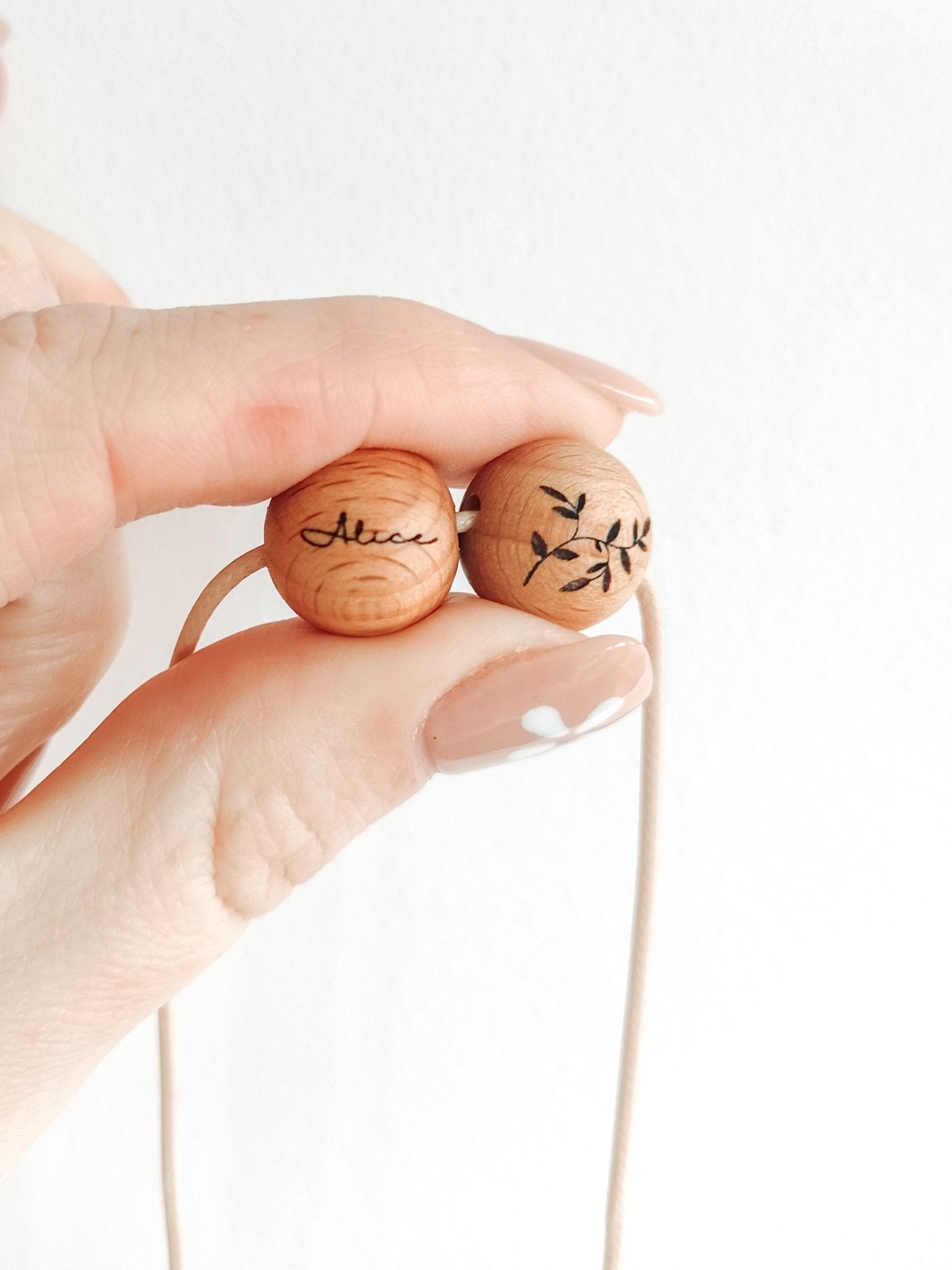 Example of engraving detail on Naturals Beechwood nursing Necklace