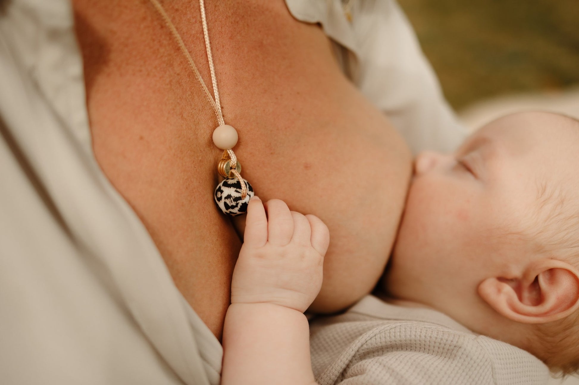 leopard print beige necklace with gold detail worn my mum being held by baby.blossy