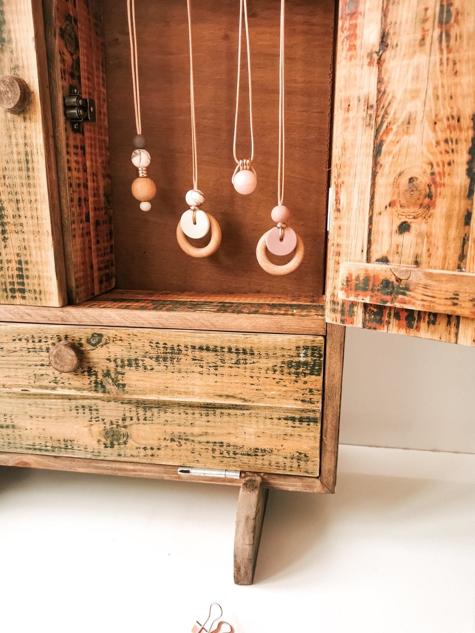 Blossy breastfeeding necklaces hung in jewellery box.